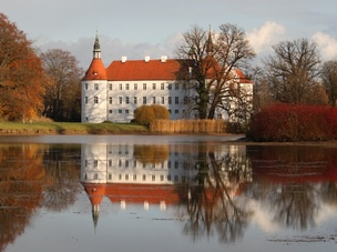 Medieval Castle by a lake in autumn